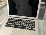 a laptop computer sitting on top of a glass table