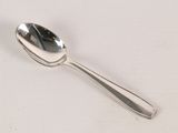 a spoon that is sitting on a white surface