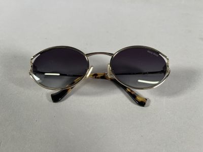 a close up of a pair of sunglasses on a white surface