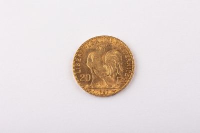 a close up of a gold coin on a white surface
