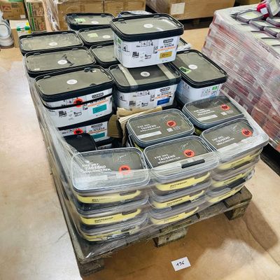 boxes of paint are stacked on a pallet in a warehouse