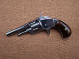 a close up of a revolver on a brown background