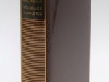 an old book with a yellow ribbon on top of it