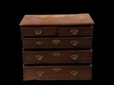 an old wooden chest of drawers with brass hardware on the drawers