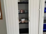 an image of a white closet with shelves and shelves