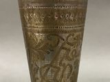 a silver cup with a design on it