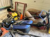 a man working on a lawn mower in a garage