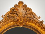 an ornately carved gold mirror with a black background