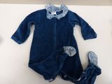 baby ' s blue dress and shoes are laying on a white surface