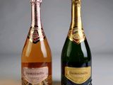 two bottles of champagne sitting next to each other on a table