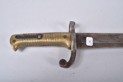 a close up of a knife on a white surface with a tag on it