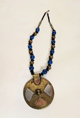 a close up of a necklace on a white surface