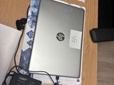 a laptop computer sitting on top of a wooden table