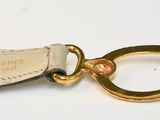 a white belt with a gold buckle on it