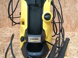 a close up of a yellow and black pressurer on a wooden surface