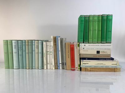 many books stacked on top of each other on a table