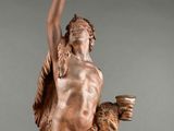bronze statue of a man holding a cup in his right hand