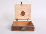 a small wooden box with an apple inside of it