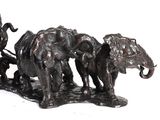 a statue of a man riding a horse drawn carriage with elephants
