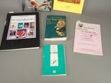 several books are sitting on a table next to each other
