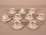 nine cups and saucers on the table with saucers