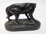 a statue of a dog that is standing on a base
