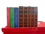 a stack of books sitting on top of a red box