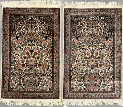 two antique persian rugs, one with a floral design and the other with a floral design