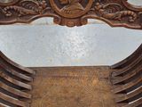 a wooden chair that has a carved seat on top of it