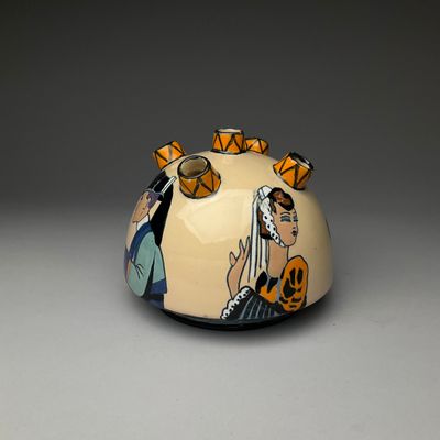 a vase with a picture of a woman and a man on it