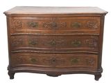 a wooden chest of drawers with ornate carvings on the drawers