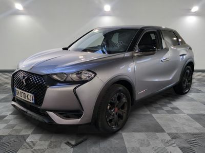 the front view of a silver suv parked on a checkered floor