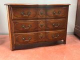 a wooden dresser with many drawers on it in a room