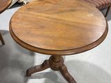 several chairs and a table in a room with a lot of furniture in the background