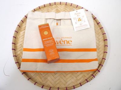 a bag with a bottle of sunscreen and a bottle of sunscreen sitting on top of it