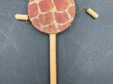 a close up of a wooden stick with a giraffe pattern on it
