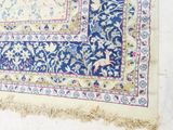 an image of a blue and yellow rug hanging on a wall