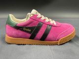 the pink and green sneakers are on a gray surface