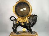 a statue of a lion on top of a clock
