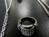 a necklace, ring, and earrings sitting on a table