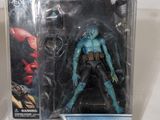 the action figure is in a plastic box on a white surface