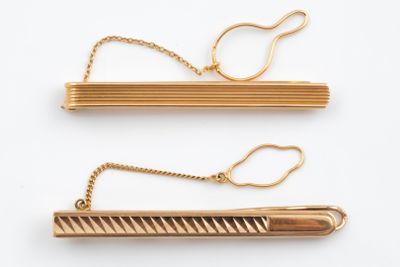 two pairs of gold plated hair clips on a white background