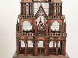 a wooden model of a castle sitting on a table