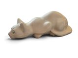 a cat figurine that is laying down on the ground