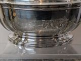 a silver bowl with a lid sitting on a table