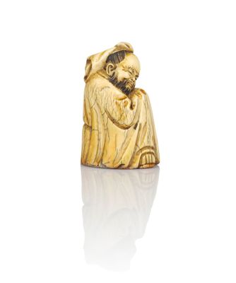 an antique carved ivory figurine of a man with a beard