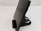 a tablet computer sitting on a stand on a white surface