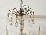 a crystal chandelier with candles on the table