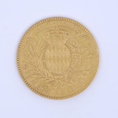 a close up of a gold coin on a white surface