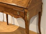 a wooden desk with a drawer on top of it